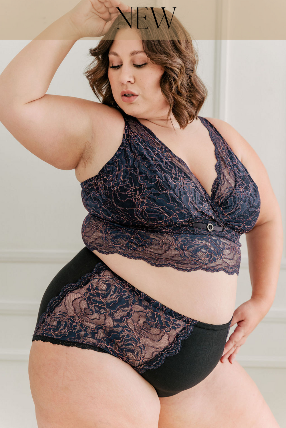 Plus size women wearing blue and pink longline bra for fuller busts. #color_iris